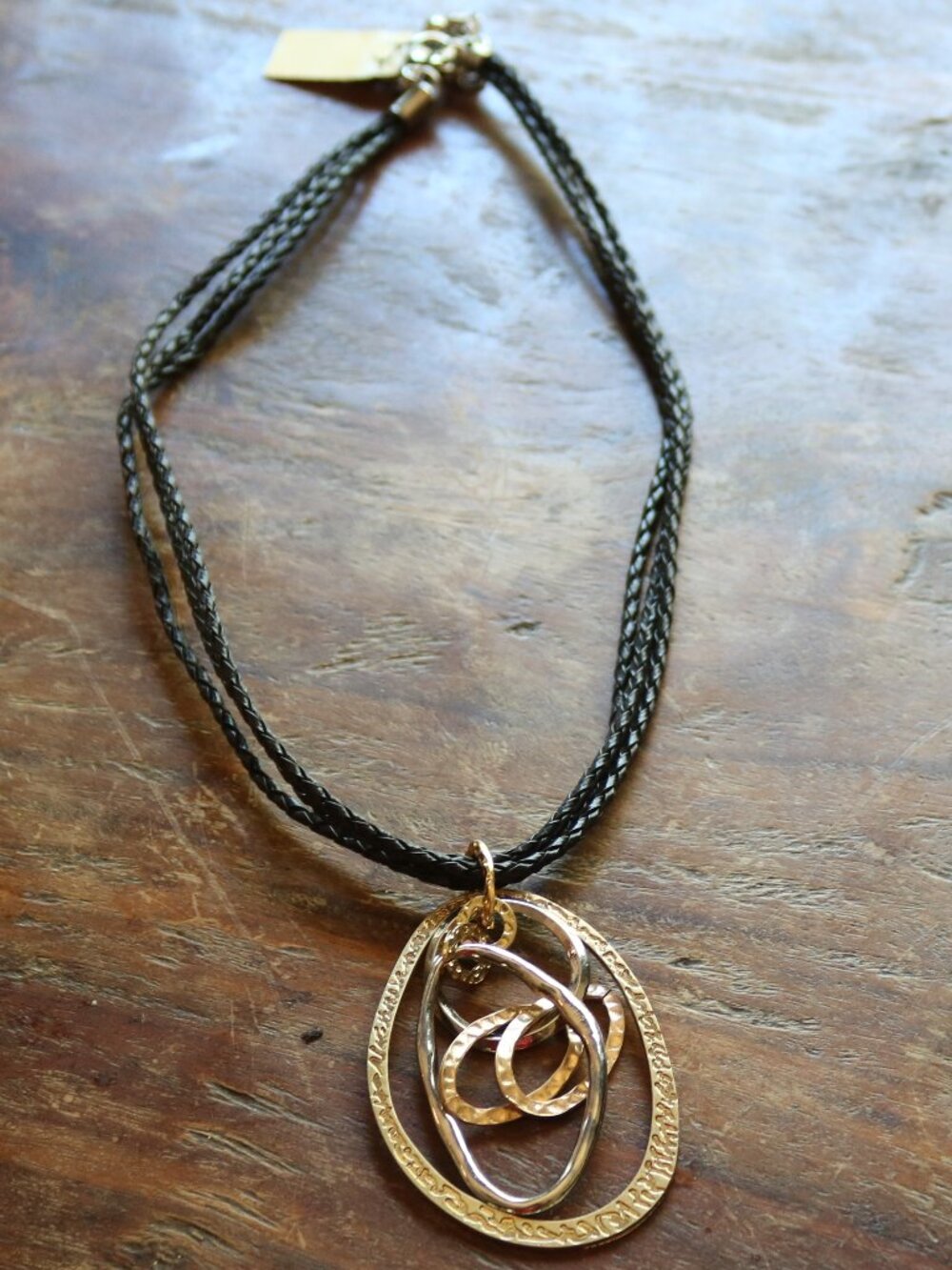 Leather corded necklace with multi metal ornament